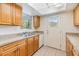 Bright kitchen with tile floors, light cabinets, and stainless steel sink at 1485 Lakeview Rd # 19, Clearwater, FL 33756