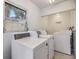 Well-lit laundry room with multiple washing machines and a window at 1485 Lakeview Rd # 19, Clearwater, FL 33756