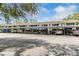 Long view of a covered parking area alongside a multi-unit building with several parked cars at 1485 Lakeview Rd # 19, Clearwater, FL 33756