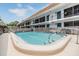 Shared community pool offering recreational amenities with an adjacent condominium building at 1485 Lakeview Rd # 19, Clearwater, FL 33756