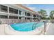 Shared community pool area with lounge chairs and an adjacent multi-story condominium building at 1485 Lakeview Rd # 19, Clearwater, FL 33756