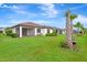 Backyard featuring lush green grass, manicured landscaping, and a screened-in patio at 16723 Blackwater Ter, Bradenton, FL 34202