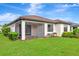 Spacious backyard with a covered patio, lush lawn, and manicured landscaping at 16723 Blackwater Ter, Bradenton, FL 34202