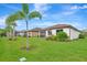 Well-maintained backyard with lush green grass, beautiful landscaping, and a view of neighboring houses at 16723 Blackwater Ter, Bradenton, FL 34202