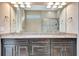 Bathroom features a double sink vanity with granite countertops and a framed mirror at 16723 Blackwater Ter, Bradenton, FL 34202