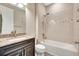 Clean bathroom featuring a tub/shower with tile surround, granite counters, and dark wood cabinetry at 16723 Blackwater Ter, Bradenton, FL 34202