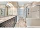 Bathroom features dual sinks with granite countertops, a glass shower, and a view into a walk-in closet at 16723 Blackwater Ter, Bradenton, FL 34202