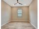 Bright bedroom with tile flooring, neutral wall, and a ceiling fan at 16723 Blackwater Ter, Bradenton, FL 34202