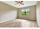 Bright bedroom features a ceiling fan, wood-look flooring and a large window overlooking the green outdoors at 16723 Blackwater Ter, Bradenton, FL 34202