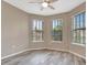 Bright bedroom featuring wood-look floors, neutral paint, and three large windows with blinds at 16723 Blackwater Ter, Bradenton, FL 34202