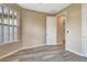 Neutral-toned bedroom featuring wood-look tile flooring and natural light from the large window at 16723 Blackwater Ter, Bradenton, FL 34202