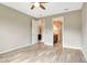 Empty bedroom features wood-look tile flooring and entry to a walk-in closet and en-suite bathroom at 16723 Blackwater Ter, Bradenton, FL 34202