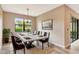 Dining area features a modern light fixture, a large window with a view, and a sliding glass door at 16723 Blackwater Ter, Bradenton, FL 34202