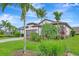 Tastefully landscaped front yard with palm trees, flowers, and a brick driveway at 16723 Blackwater Ter, Bradenton, FL 34202