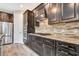 Well-equipped kitchen with stainless steel appliances, granite countertops, tile backsplash, and ample cabinet space at 16723 Blackwater Ter, Bradenton, FL 34202