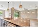 Open-concept kitchen featuring granite countertops, stainless steel appliances, and seamless access to the living area at 16723 Blackwater Ter, Bradenton, FL 34202