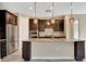Beautiful kitchen with dark wood cabinets, an island, granite countertops, and stainless steel appliances at 16723 Blackwater Ter, Bradenton, FL 34202