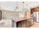 Modern kitchen featuring a large island, granite countertops, stainless appliances, and open floor plan at 16723 Blackwater Ter, Bradenton, FL 34202