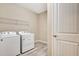 Efficient laundry room featuring a washer, dryer, wire shelving, and a door at 16723 Blackwater Ter, Bradenton, FL 34202