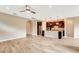 Open-concept living space with modern kitchen, wood-look tile flooring, and recessed lighting throughout at 16723 Blackwater Ter, Bradenton, FL 34202