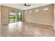 Light-filled living area with tiled floors, a ceiling fan, and glass sliding doors to the patio at 16723 Blackwater Ter, Bradenton, FL 34202