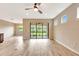 Bright living room featuring neutral walls, tile floors, recessed lighting, and sliding glass door to the outdoors at 16723 Blackwater Ter, Bradenton, FL 34202
