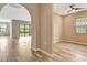 Open-concept living space with archway and sliding glass doors leading to the backyard at 16723 Blackwater Ter, Bradenton, FL 34202