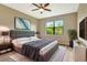 Comfortable main bedroom boasts a ceiling fan, large window, and stylish decor with plenty of natural light at 16723 Blackwater Ter, Bradenton, FL 34202