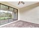 Cozy outdoor brick patio with ceiling fan, access to backyard and a glimpse of the home's interior at 16723 Blackwater Ter, Bradenton, FL 34202