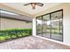 Screened lanai with brick pavers and ceiling fans, providing a relaxing outdoor living space at 16723 Blackwater Ter, Bradenton, FL 34202