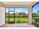 Enclosed patio overlooking well-manicured backyard with lush green lawn and trees at 16723 Blackwater Ter, Bradenton, FL 34202