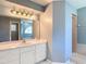 Bathroom with a single sink vanity, large mirror and walk-in shower at 1914 Henley Rd, Lutz, FL 33558