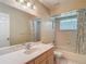 Bathroom featuring a shower/tub combo, single sink vanity and tile flooring at 1914 Henley Rd, Lutz, FL 33558