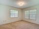 Well-lit bedroom features carpet and windows that brighten the entire space at 1914 Henley Rd, Lutz, FL 33558