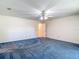 Spacious carpeted bedroom with a ceiling fan and neutral walls at 1914 Henley Rd, Lutz, FL 33558