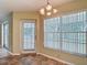 Sunny breakfast nook with tile flooring, large windows, and access to the outdoor space at 1914 Henley Rd, Lutz, FL 33558