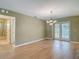 Spacious dining area with hardwood floors, classic chandelier, and access to the backyard at 1914 Henley Rd, Lutz, FL 33558
