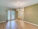 Bright dining room with hardwood floors, chandelier, and sliding doors leading to outdoor space at 1914 Henley Rd, Lutz, FL 33558