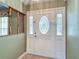 Elegant front door with decorative oval glass insert and sidelights, enhancing curb appeal at 1914 Henley Rd, Lutz, FL 33558