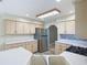 Bright kitchen with stainless steel appliances, light wood cabinets, and white countertops at 1914 Henley Rd, Lutz, FL 33558