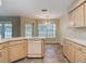Bright kitchen area featuring tile floors, practical appliances, and plentiful countertop space at 1914 Henley Rd, Lutz, FL 33558