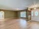 Inviting living room featuring hardwood floors, ample natural light, and a decorative front door at 1914 Henley Rd, Lutz, FL 33558