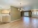 Open living space featuring hardwood floors connecting the kitchen and living room with natural light at 1914 Henley Rd, Lutz, FL 33558