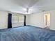 Spacious main bedroom featuring neutral walls, blue carpets and plenty of natural light at 1914 Henley Rd, Lutz, FL 33558