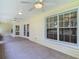 Screened-in porch featuring tiled floors, ceiling fans, and serene outdoor views at 1914 Henley Rd, Lutz, FL 33558