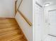 Staircase with wooden steps, white walls, and a wooden handrail at 1914 Henley Rd, Lutz, FL 33558