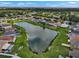 Aerial view of homes surrounding a calm pond in a residential neighborhood at 1933 Fruitridge St, Brandon, FL 33510