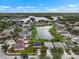 An aerial view of a residential community surrounding a large pond on a sunny day at 1933 Fruitridge St, Brandon, FL 33510