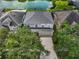 An aerial view of a two-story home with a gray roof, a lake view, and lush landscaping at 1933 Fruitridge St, Brandon, FL 33510