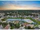 A picturesque view of a community surrounding a lake at sunset, showcasing many homes and lush trees at 1933 Fruitridge St, Brandon, FL 33510